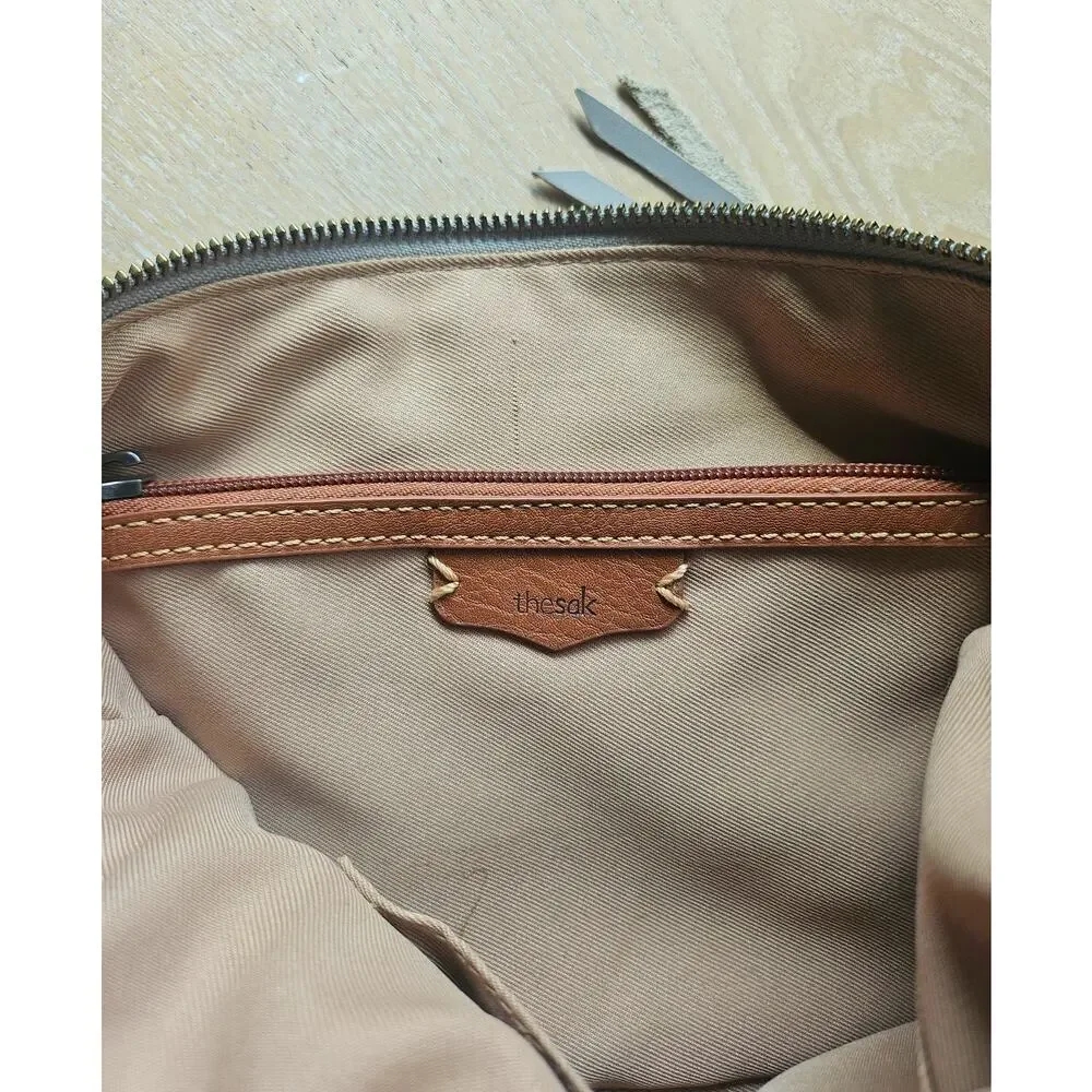 The Sak Stone Gray Leather Crossbody, adjustable, tassel detail
